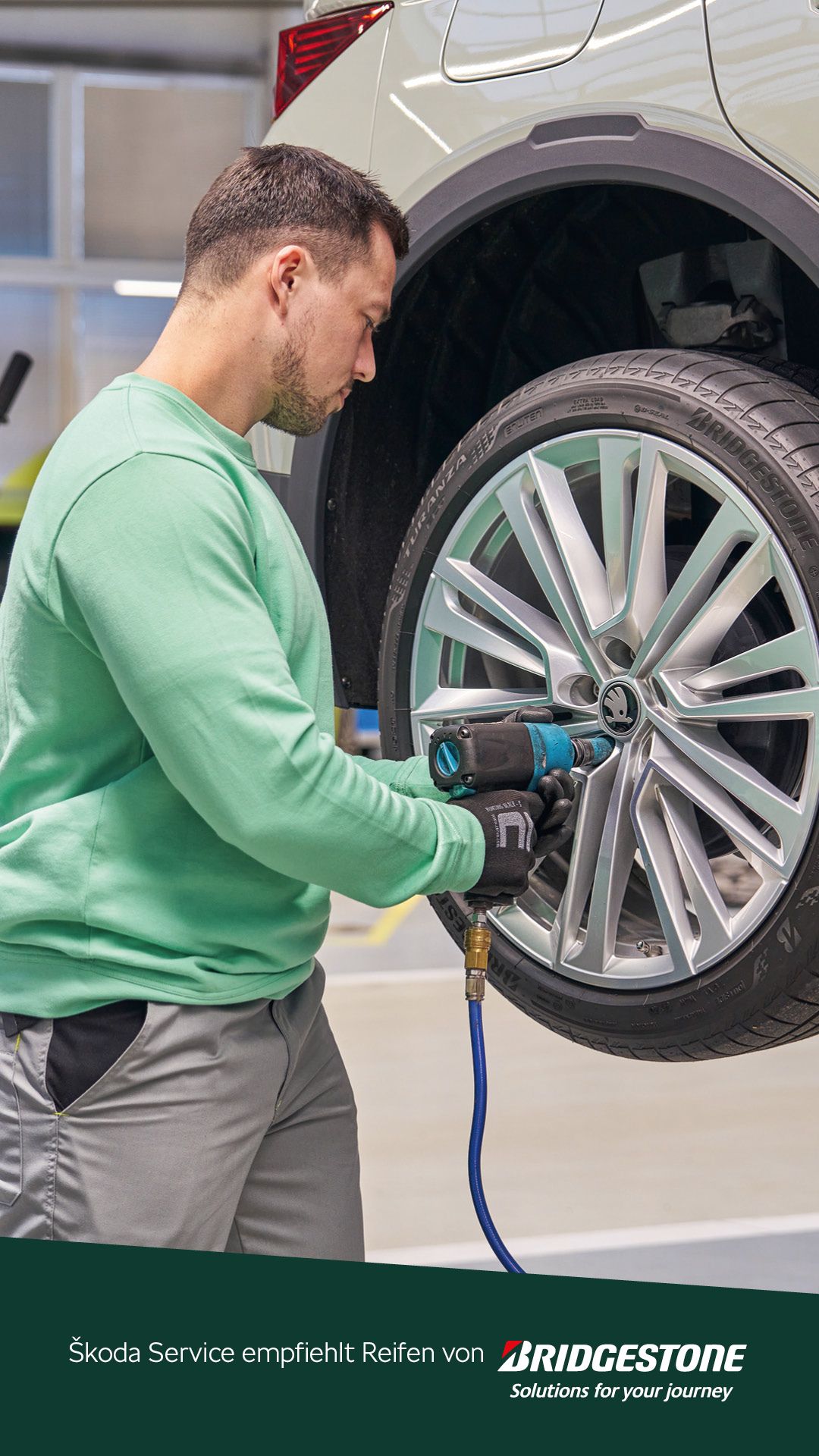 Ein Škoda Mechaniker beim Räderwechsel.